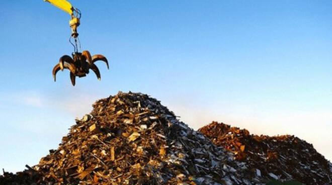 Pile of scrap metal with crane