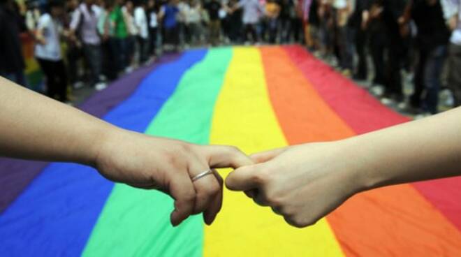 Gay and lesbian activists form a human chain around a rainbow flag during celebrations marking the fourth annual International Day Against Homophobia (IDAHO) in Hong Kong on May 18, 2008. The International Day Against Homophobia, marked in most places aro